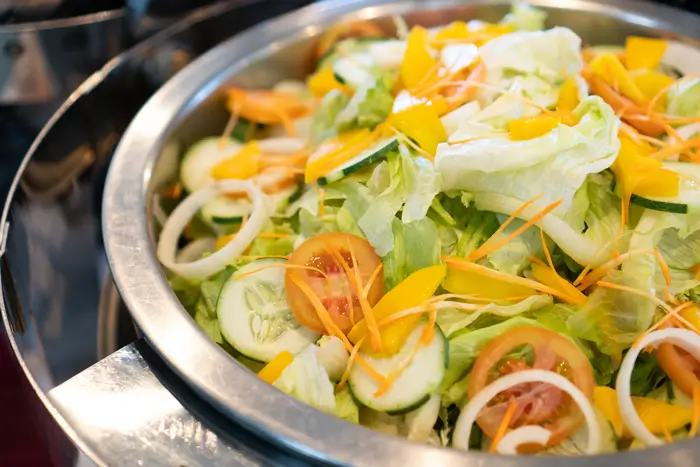 a bowl of salad on a stove