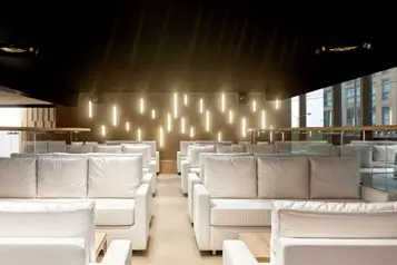 a room with white couches and lights