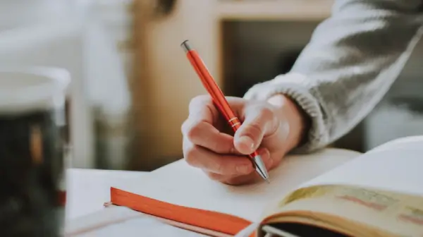 hand with red pen